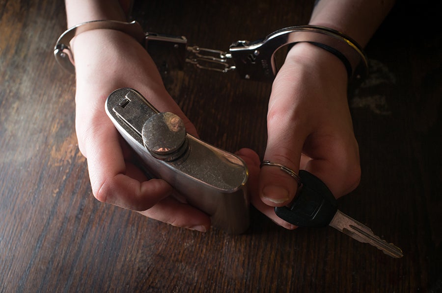 a person holding a flask and car keys